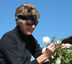 Woman using an early Genoa Services headband while gardening
