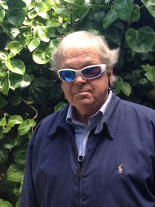 Blind man Ed Gallagher, using Genoa Services. Only the wide-angle lens of the genoa system sticking out of the front of his zipped up jacket.